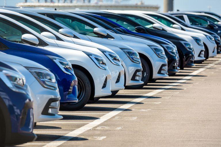 Brand new Renault cars lined up in a parking lot.